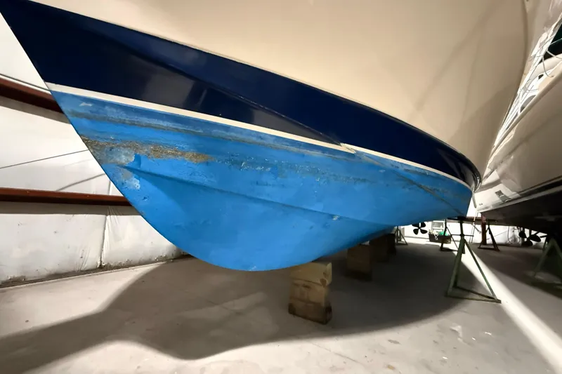 Slide: The Image of 1979 Chris-Craft 350 Catalina boat hull in storage, showing blue and white paint. - 29
