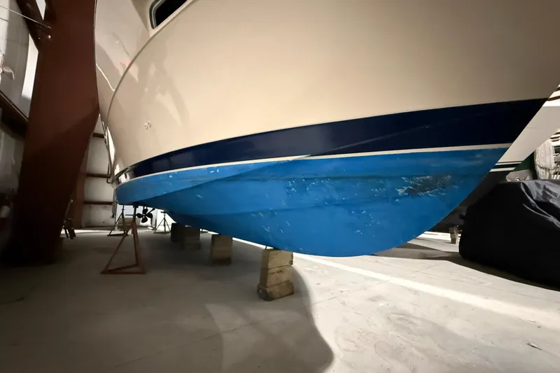 Slide: The Image of 1979 Chris-Craft 350 Catalina boat hull in storage, showcasing blue and white paint. - 30