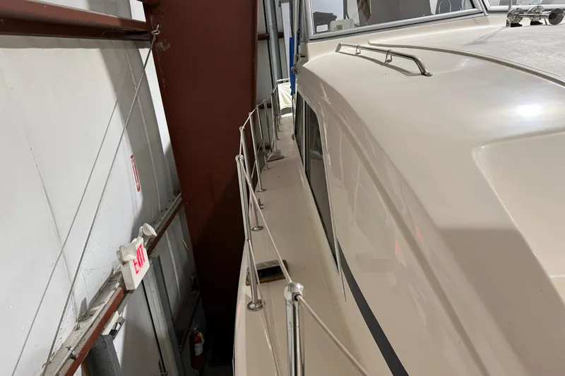 Slide: The Image of 1979 Chris-Craft 350 Catalina yacht in storage, side view with railing and cabin details. - 4
