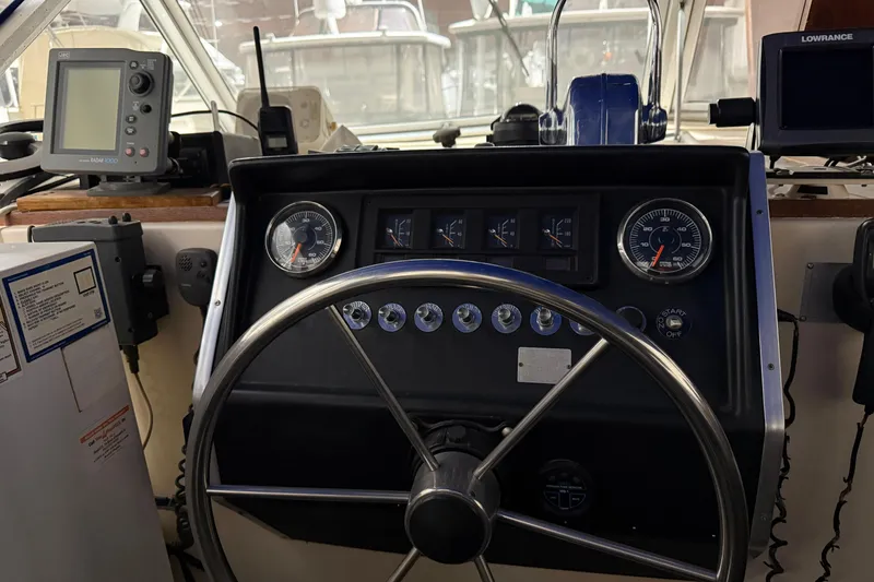 Slide: The Image of 1979 Chris-Craft 350 Catalina boat dashboard with steering wheel and navigation instruments. - 5