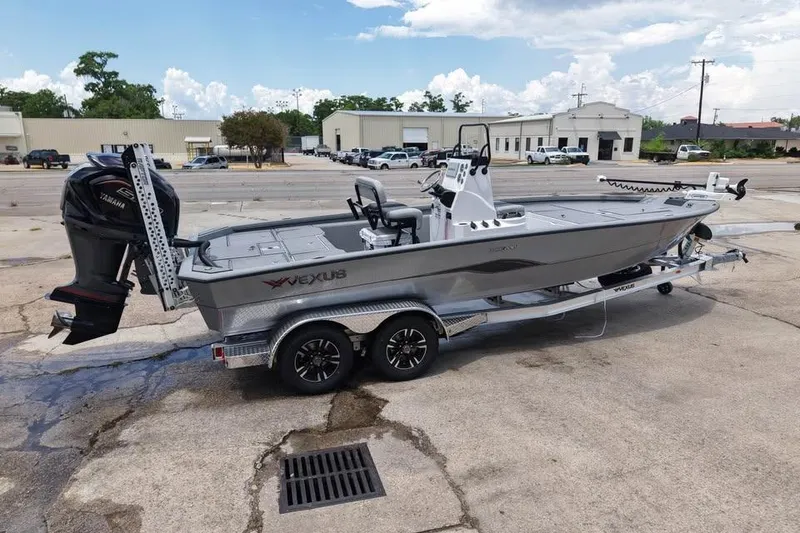 Slide: The Image of 2026 Vexus ACX 2210 boat on trailer, parked outdoors with Yamaha motor. - 1