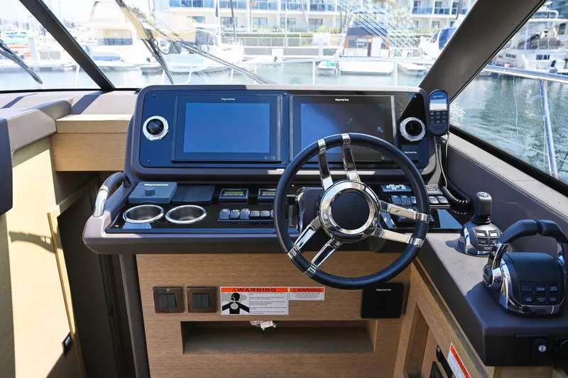 Slide: The Image of Cockpit of 2020 Prestige 460S yacht with modern navigation equipment and steering wheel. - 10