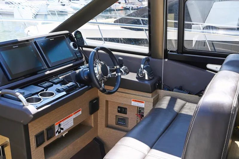 Slide: The Image of Interior cockpit of 2020 Prestige 460S yacht with modern navigation equipment and leather seating. - 11