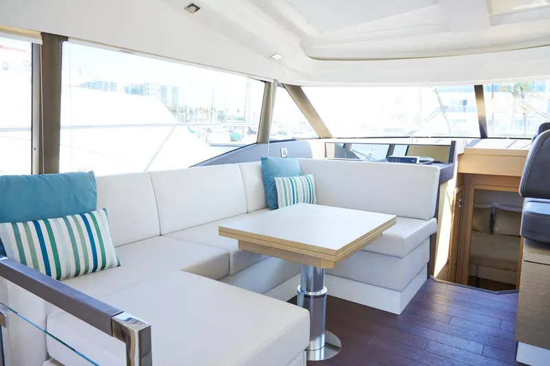 Slide: The Image of Luxurious interior of 2020 Prestige 460S yacht with white seating and striped cushions. - 13