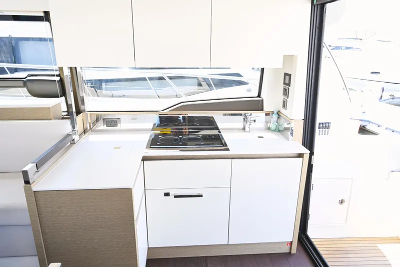 Slide: The Image of Modern kitchen interior on a 2020 Prestige 460S yacht, featuring sleek cabinetry and appliances. - 16