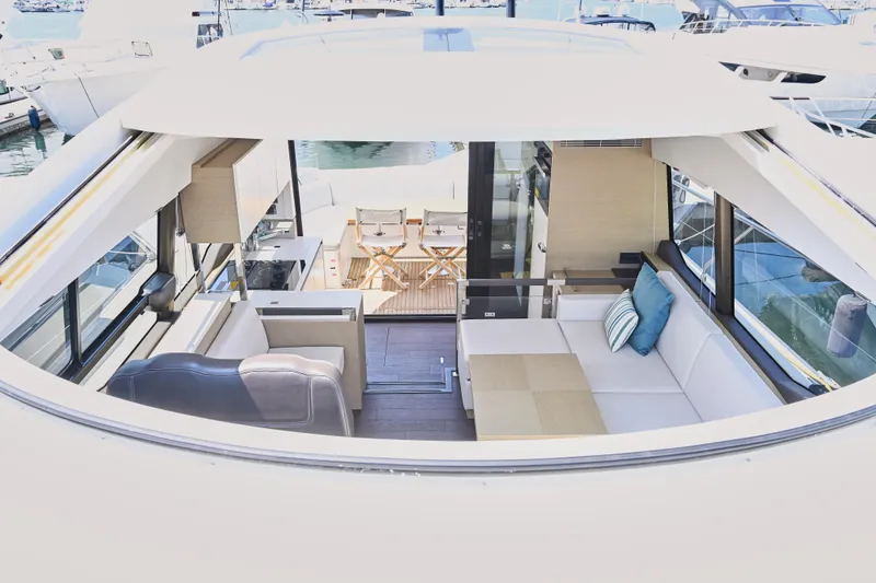 Slide: The Image of Luxurious 2020 Prestige 460S yacht interior with modern seating and outdoor dining area. - 18