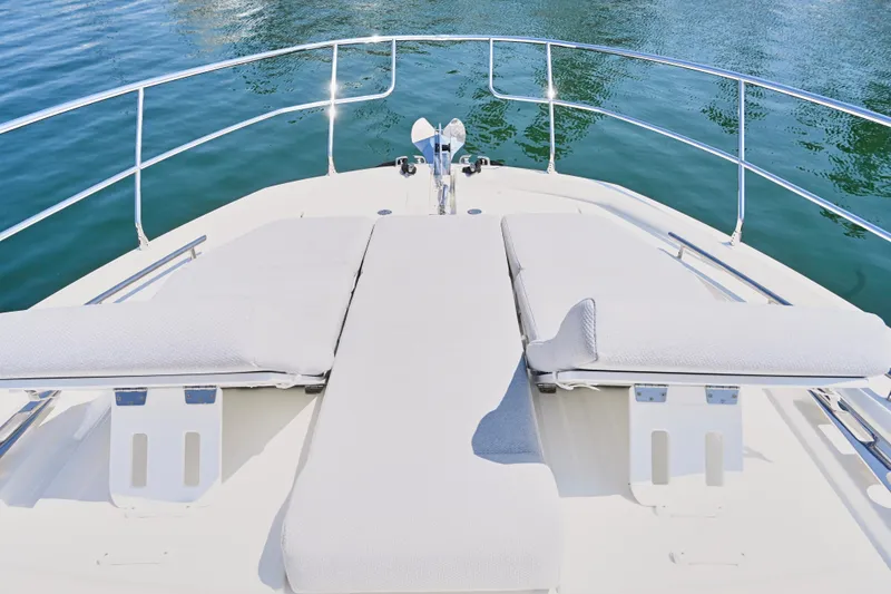 Slide: The Image of Prestige 460S 2020 yacht bow with sun loungers on calm water. - 19