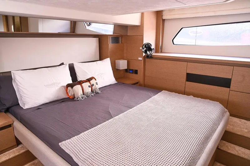 Slide: The Image of Luxurious bedroom interior of a 2020 Prestige 460S yacht with modern design and cozy bedding. - 22
