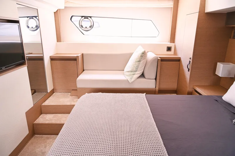 Slide: The Image of Luxurious interior of a 2020 Prestige 460S yacht, featuring a cozy bedroom and seating area. - 24