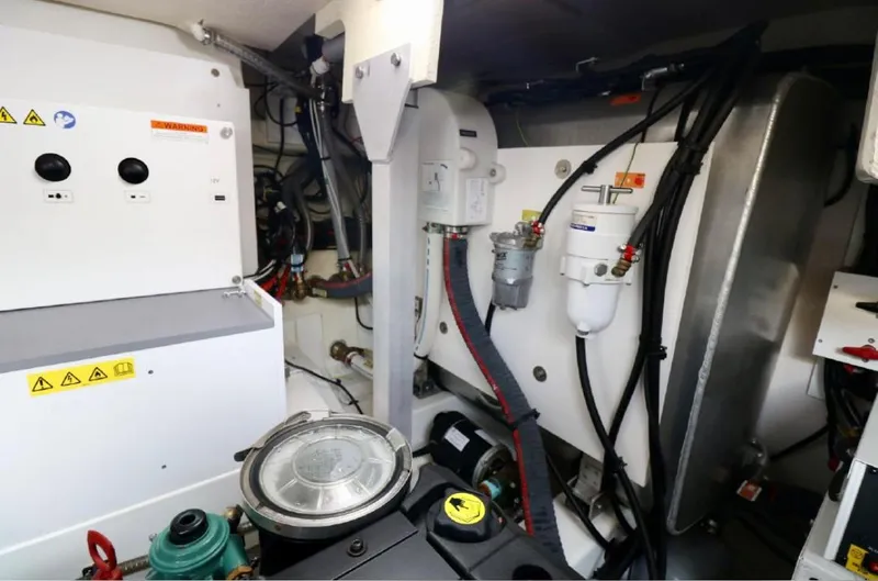 Slide: The Image of Engine room of a 2020 Prestige 460S yacht, showcasing mechanical components and wiring. - 32