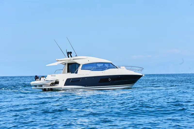 Slide: The Image of 2020 Prestige 460S yacht cruising on open blue sea under clear sky. - 4