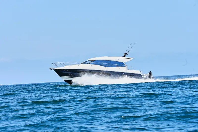 Slide: The Image of 2020 Prestige 460S yacht cruising on open sea under clear blue sky. - 6