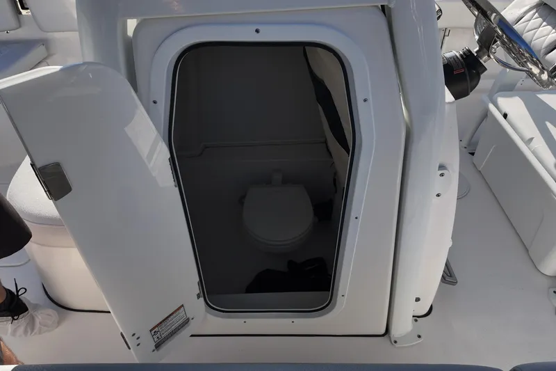 Slide: The Image of 2026 Sea Fox 248 Commander boat interior with open door revealing compact toilet. - 10