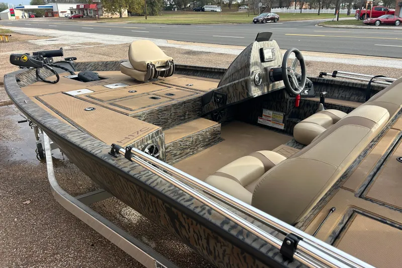 Slide: The Image of 2023 Xpress H17C Crappie fishing boat with camo design and modern seating. - 4