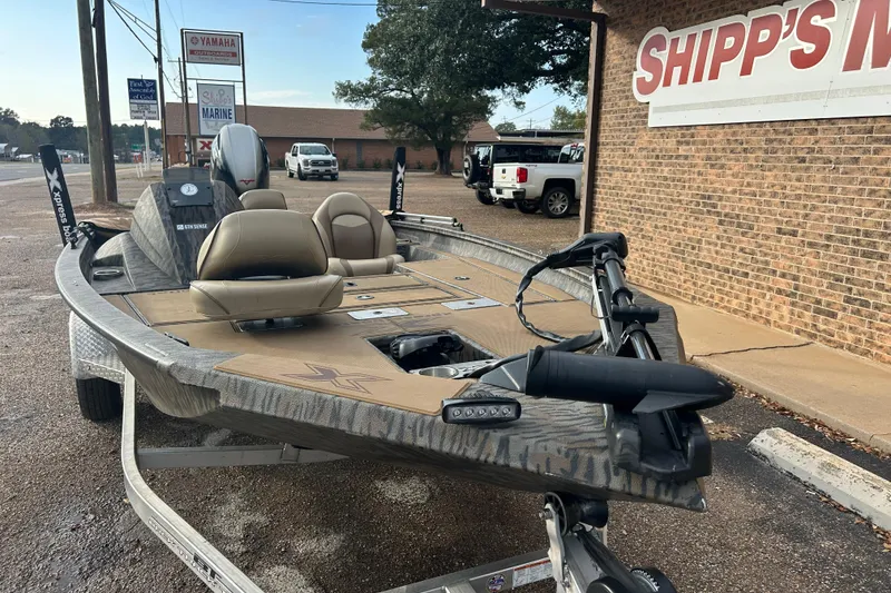 Slide: The Image of 2023 Xpress H17C Crappie boat on trailer outside Shipp's Marine store. - 5