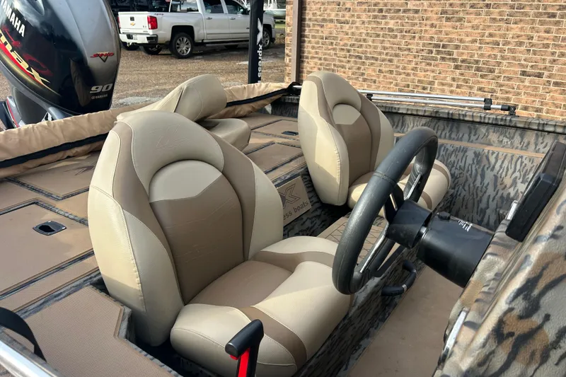 Slide: The Image of 2023 Xpress H17C Crappie boat interior with steering wheel and seats. - 6