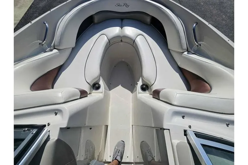 Slide: The Image of 2006 Sea Ray 220 Select boat interior with white cushioned seating and sleek design. - 3