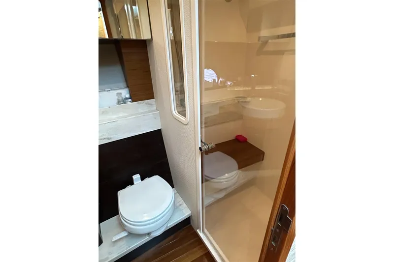 Slide: The Image of Bathroom interior of 2017 Tiara Yachts C39 Coupe with modern fixtures and wooden accents. - 17