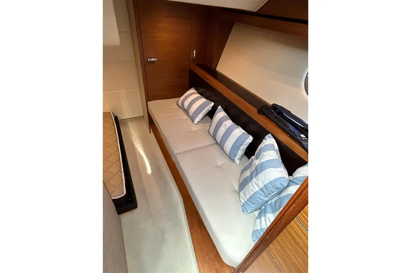 Slide: The Image of 2017 Tiara Yachts C39 Coupe interior with striped cushions and wooden accents. - 12