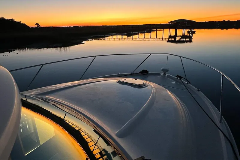Slide: The Image of 2017 Tiara Yachts C39 Coupe at sunset on calm waters. - 19