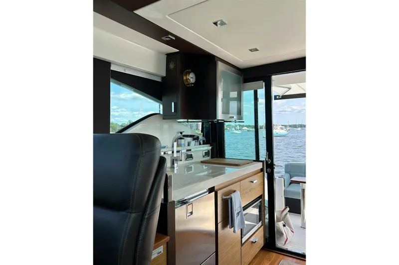 Slide: The Image of Interior of 2017 Tiara Yachts C39 Coupe, featuring modern kitchen and scenic water view. - 9