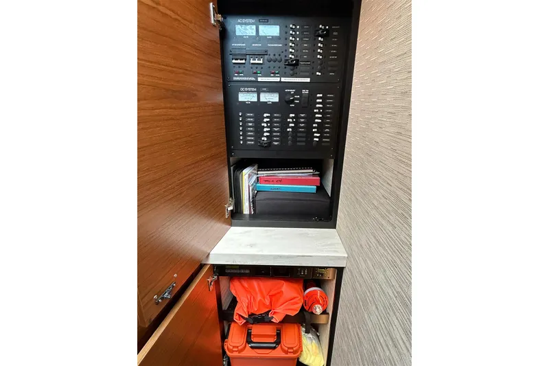 Slide: The Image of 2017 Tiara Yachts C39 Coupe electrical panel and storage cabinet interior. - 13