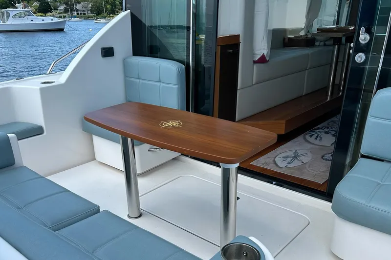 Slide: The Image of 2017 Tiara Yachts C39 Coupe interior with elegant seating and wooden table. - 7