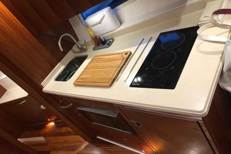Slide: The Image of Modern kitchen in 2017 Tiara Yachts C39 Coupe with sink, stove, and cutting board. - 11