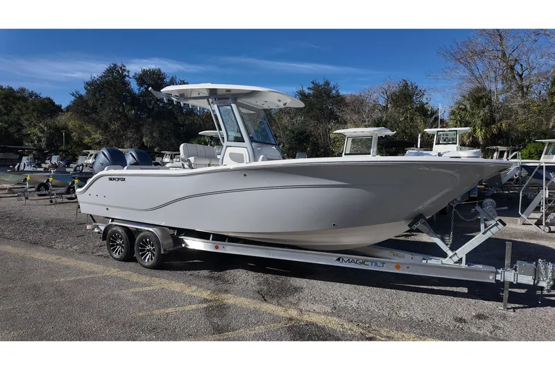 The Image of 2026 Sea Fox 268 Commander boat on trailer, parked outdoors under clear sky. - 0