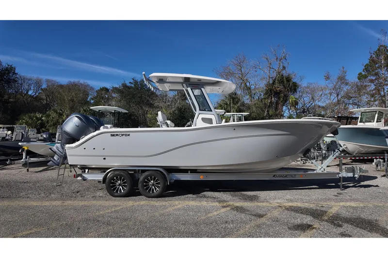 Slide: The Image of 2026 Sea Fox 268 Commander boat on trailer, parked outdoors. - 1