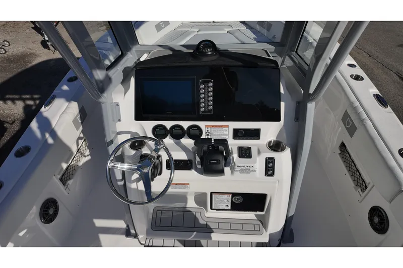 Slide: The Image of 2026 Sea Fox 268 Commander boat dashboard with steering wheel and control panel. - 21