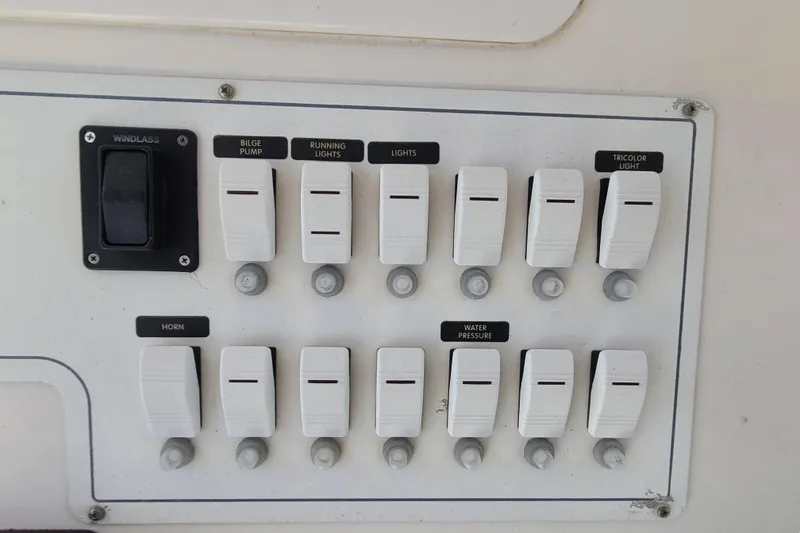 Slide: The Image of Control panel of a 2005 Pro-Line 24 Sport boat with labeled switches. - 14