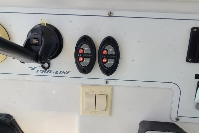 Slide: The Image of Control panel of a 2005 Pro-Line 24 Sport boat with trim and bow switches. - 15