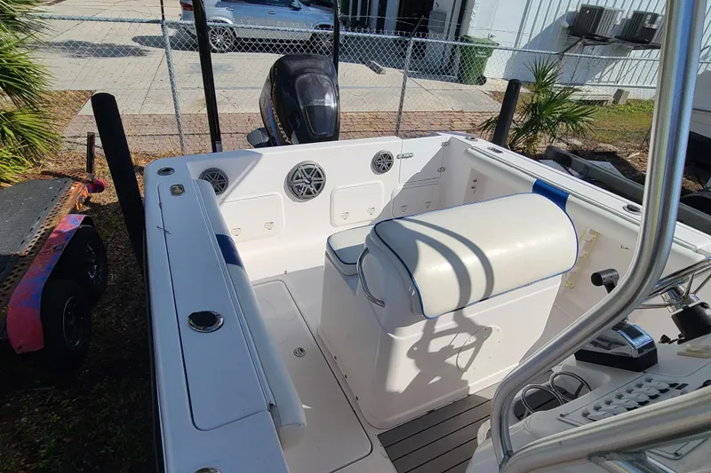 Slide: The Image of 2005 Pro-Line 24 Sport boat interior with seating and controls, parked outdoors. - 22