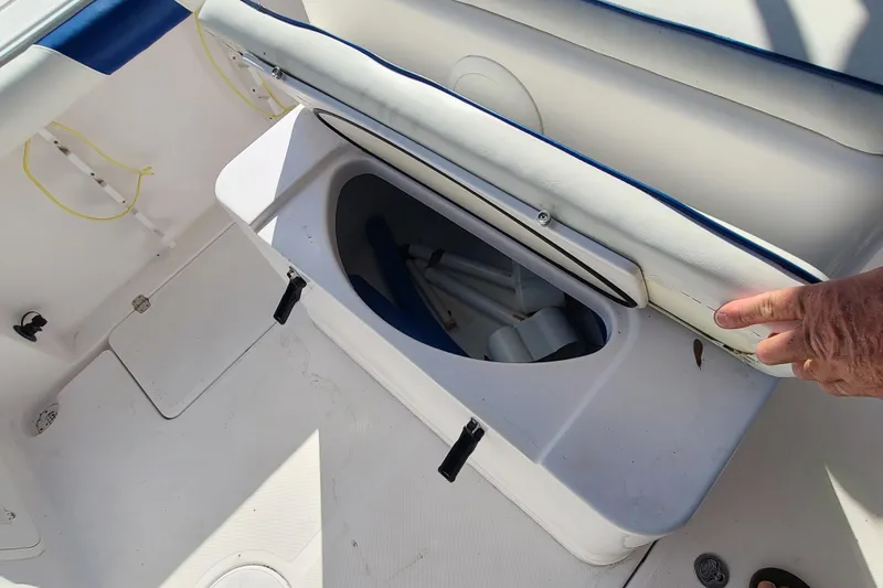 Slide: The Image of Open storage compartment on 2005 Pro-Line 24 Sport boat with white seating. - 23