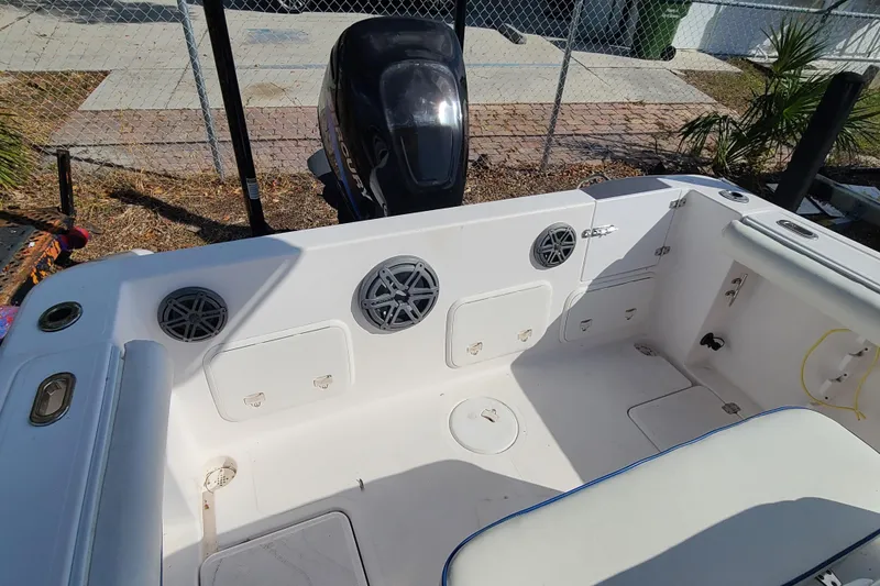 Slide: The Image of 2005 Pro-Line 24 Sport boat interior with storage compartments and speakers. - 24