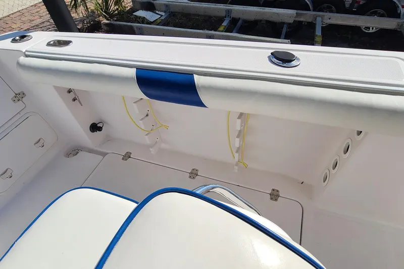 Slide: The Image of 2005 Pro-Line 24 Sport boat interior with white and blue seating. - 26