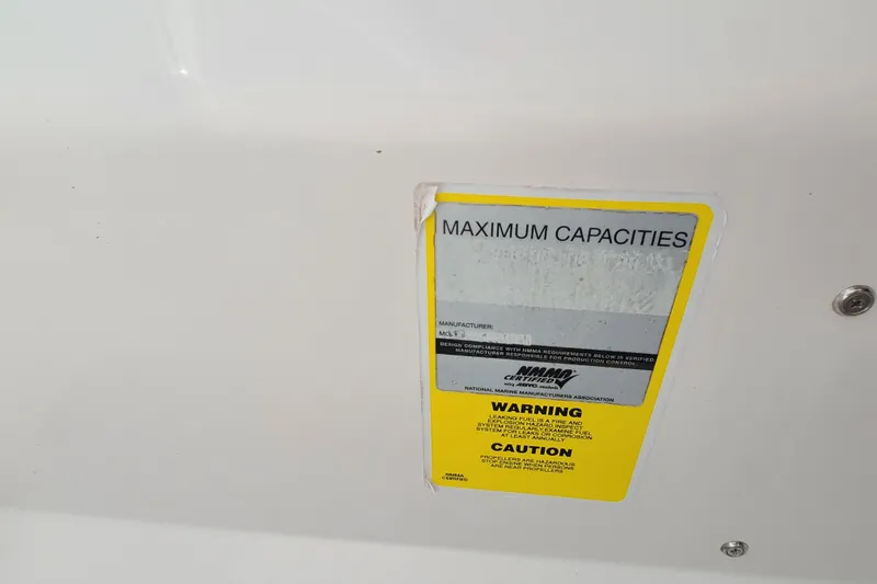Slide: The Image of 2005 Pro-Line 24 Sport boat capacity warning label with safety instructions. - 27