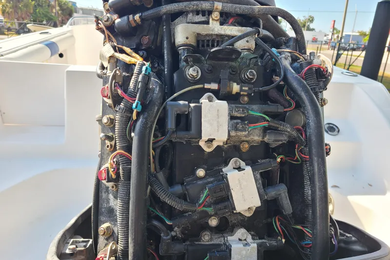 Slide: The Image of Close-up of a 2005 Pro-Line 24 Sport boat engine with visible wiring and components. - 29