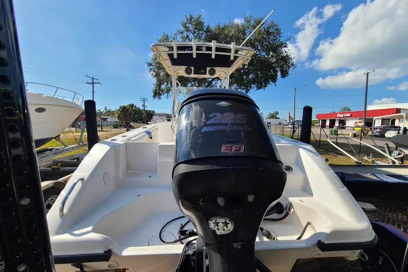 Slide: The Image of 2005 Pro-Line 24 Sport boat with Mercury 225 EFI engine, parked outdoors. - 3