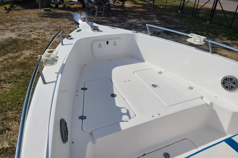 Slide: The Image of 2005 Pro-Line 24 Sport boat deck with storage compartments and railing. - 7