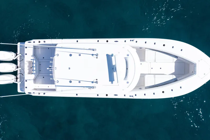 The Image of 2024 SeaVee 390B boat on calm water with city skyline in background. - 0