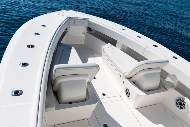 Slide: The Image of 2024 SeaVee 390B boat interior with white seating and ocean backdrop. - 10
