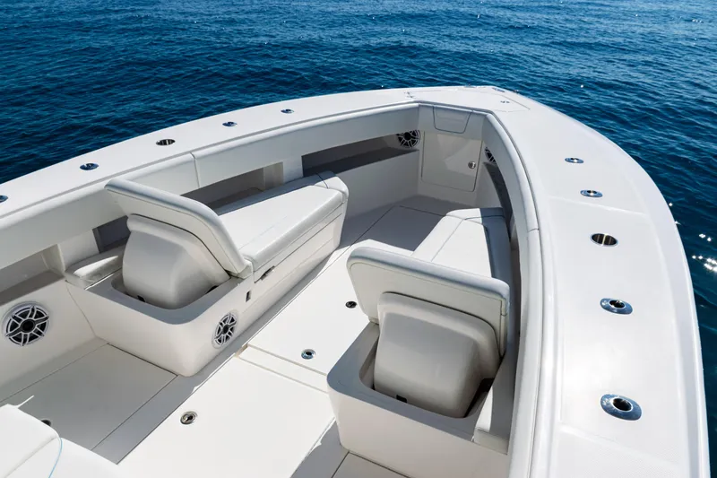 Slide: The Image of 2024 SeaVee 390B boat interior with seating, on calm ocean waters. - 13
