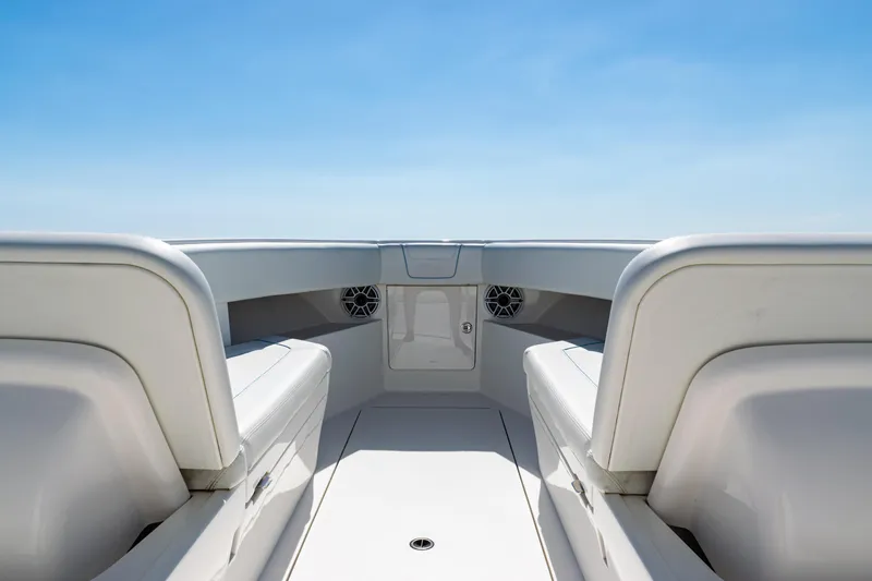 Slide: The Image of 2024 SeaVee 390B boat interior with white seating and clear blue sky. - 14
