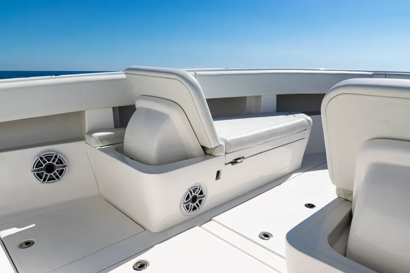 Slide: The Image of 2024 SeaVee 390B boat interior with white seating and speakers, under clear blue sky. - 15