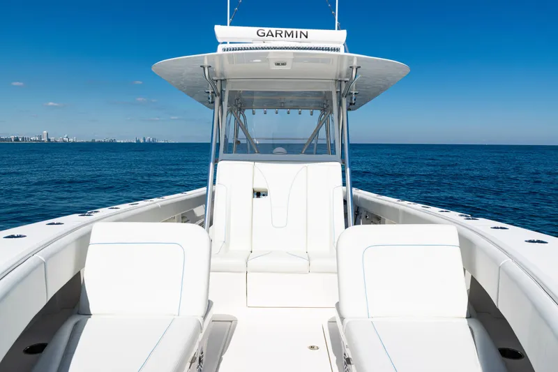 Slide: The Image of 2024 SeaVee 390B boat on open ocean, featuring sleek white seating and Garmin equipment. - 16