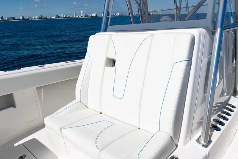 Slide: The Image of 2024 SeaVee 390B boat with white cushioned seating, ocean view in background. - 18