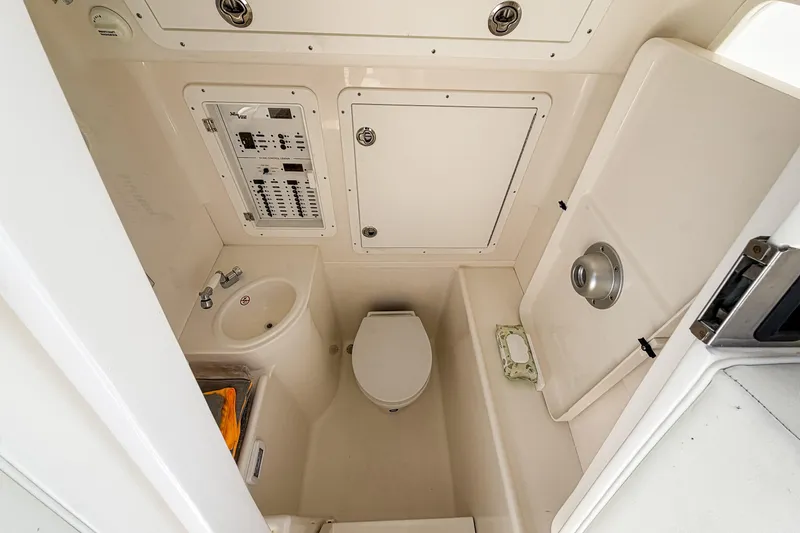 Slide: The Image of 2024 SeaVee 390B boat interior bathroom with sink, toilet, and control panel. - 19