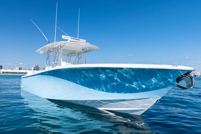 Slide: The Image of 2024 SeaVee 390B boat on clear blue water under a sunny sky. - 2